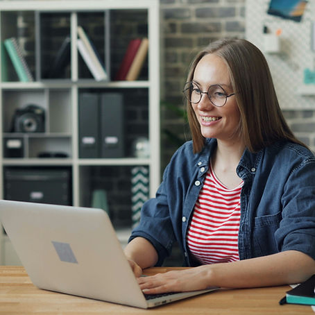 Happy woman talking looking at laptop screen in office_edited.jpg