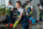 smiling-cleaner-vacuuming-floor-in-office-near-mul-2026-01-06-00-28-25-utc.jpg