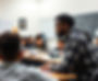 black and Latino male high school students on campus in a classroom learning from a black
