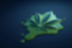 Green cannabis leaf on a dark blue surface, surrounded by a spreading green liquid