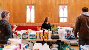 People looking at emergency supplies on tables