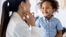 Child smiling at health care provider