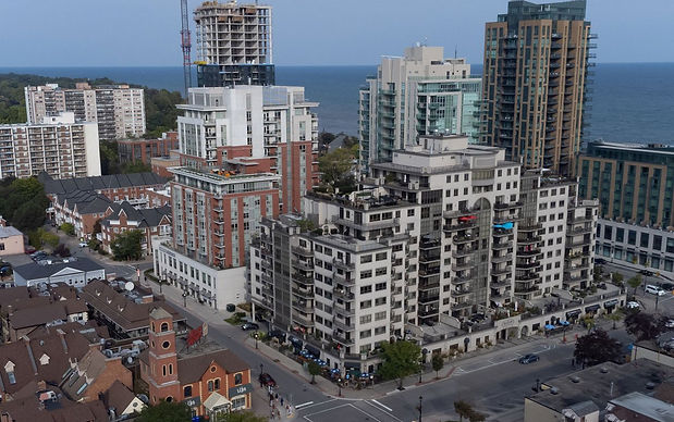 A stunning aerial view of Burlington, Ontario, featuring high-rise condominiums, mixed use developments, and a scenic waterfront along lake ontario. Irving Security Corps provides expert security services in Burlington, specializing in residential, commercial, retail and event security.