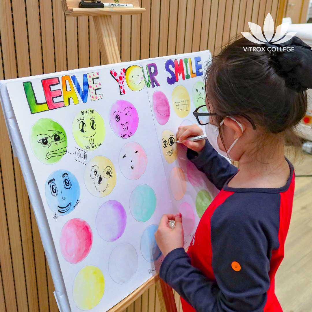 Visitor draws smiley face at our STEM interactive booth.