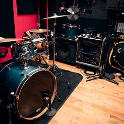 a drum kit, behind is a rack unit for music recording purposes.