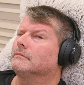 A photo of Peter listening to music on Anker over the ear headphones