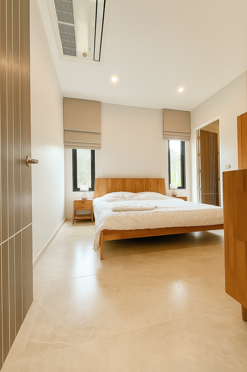 Modern bedroom with warm lighting and minimalist decor at Blue Horizon Villa