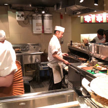 Chefs working at Yakitori restaurant and grill, charcoal grilled food, dining counter