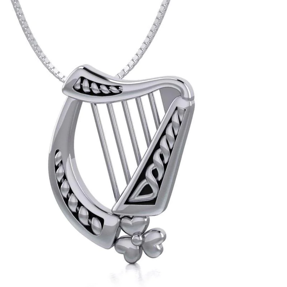 Detailed silver harp pendant featuring Celtic knotwork and shamrock accent.