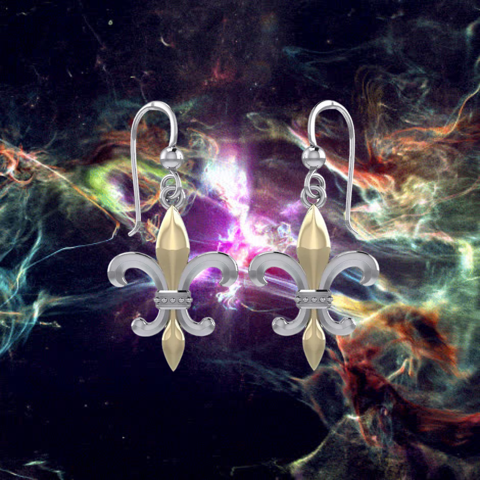Thumbnail: Pair of silver and gold fleur-de-lis dangle earrings against a cosmic background.