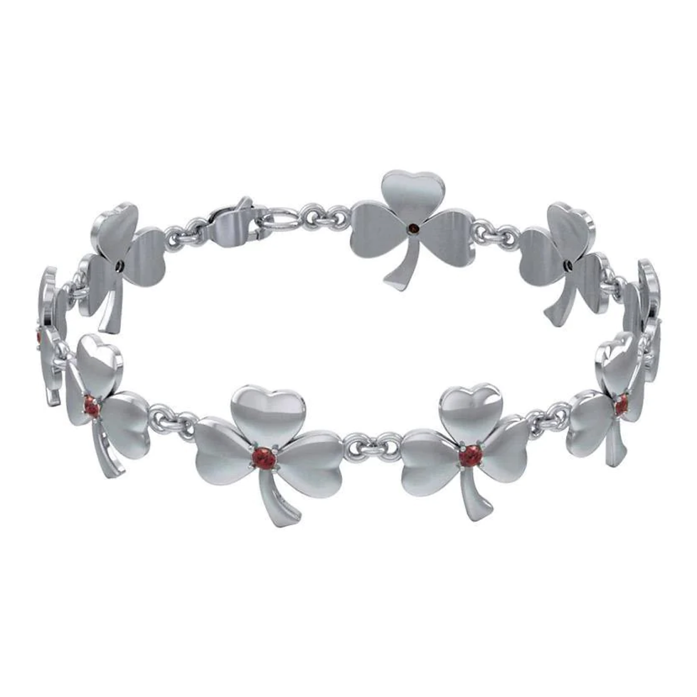 Thumbnail: Shiny silver nine-link shamrock bracelet, each clover adorned with a red gemstone.