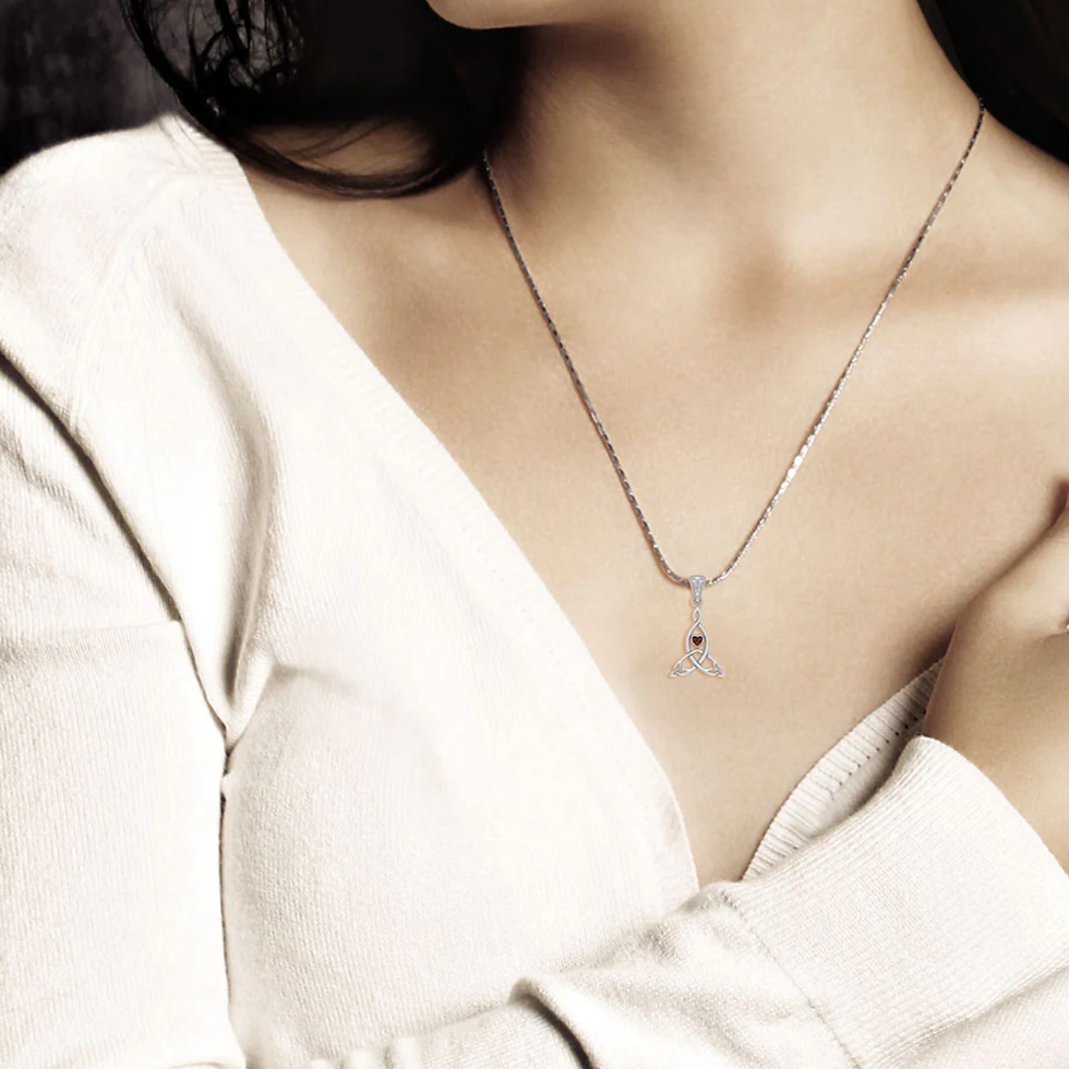Thumbnail: Woman wearing elegant silver necklace with delicate sparkling pendant.