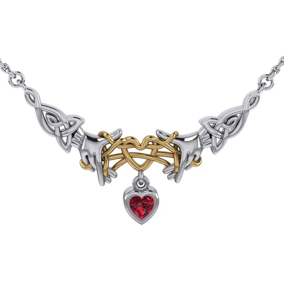 Silver and gold Celtic knot necklace with ruby heart pendant.
