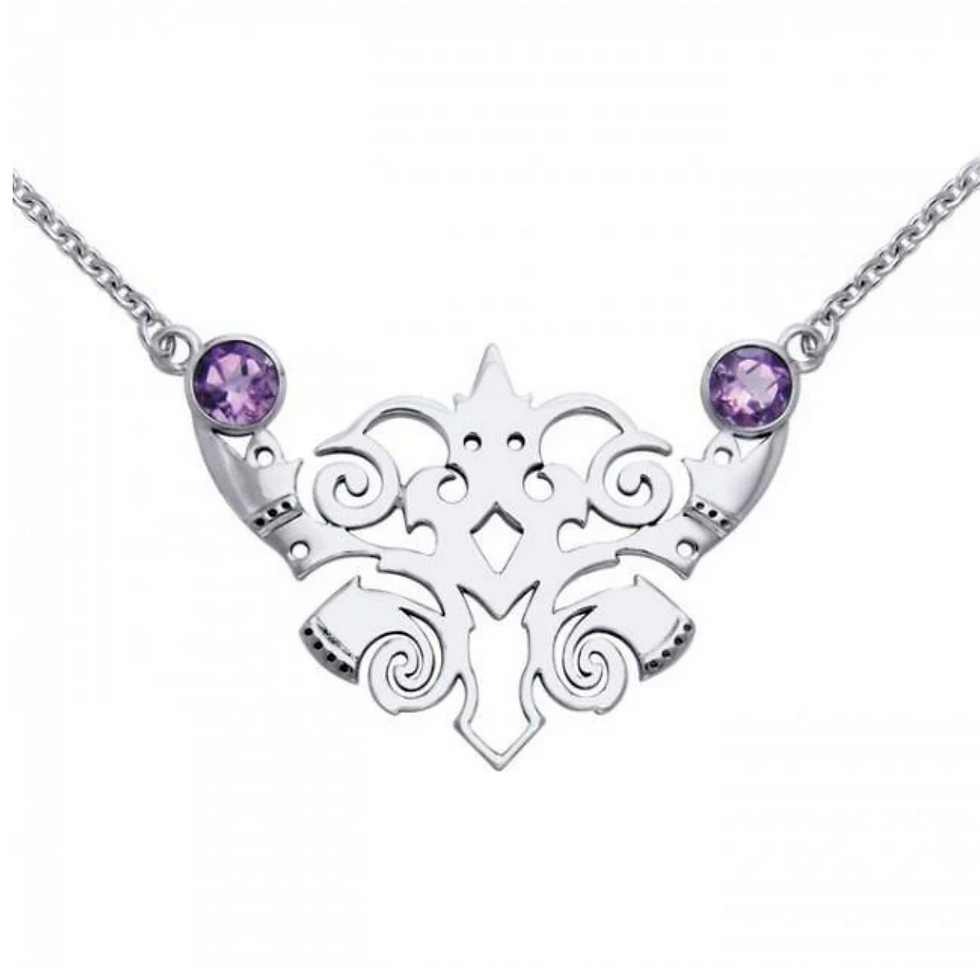 Ornate sterling silver Viking animal pendant with two purple gemstones.