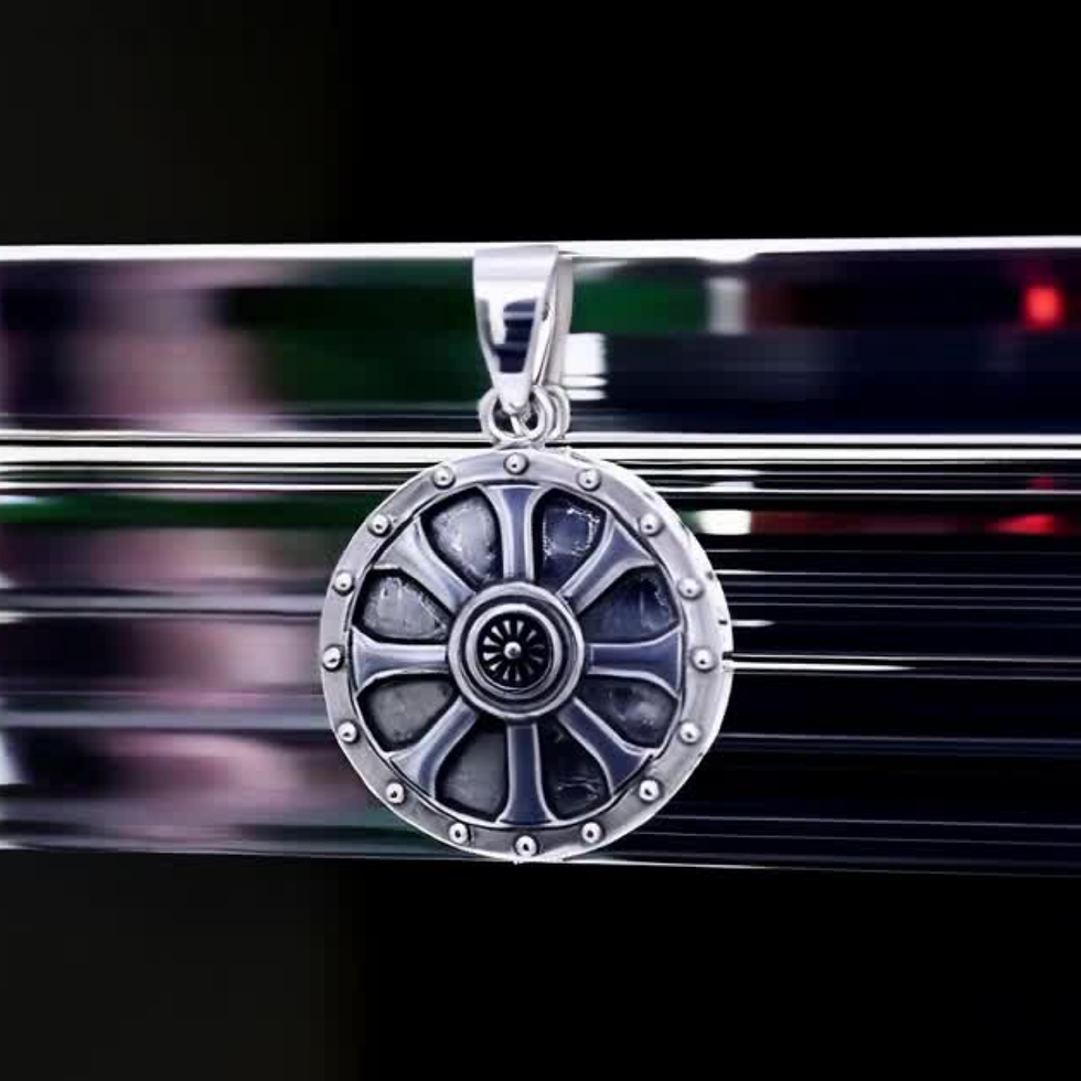 Thumbnail: Detailed sterling silver round shield pendant, symbolizing protection and strength.