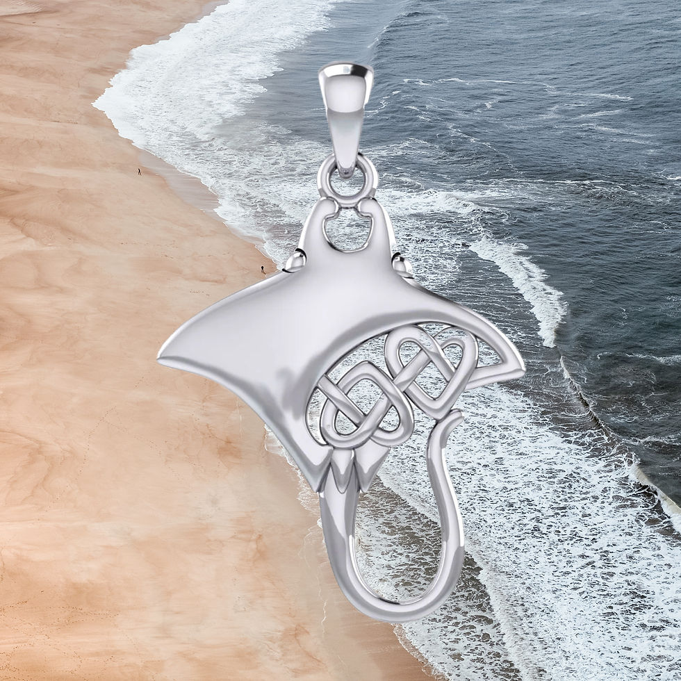 Thumbnail: Silver manta ray pendant with Celtic knot design over beach and ocean.