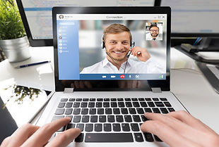 Hands typing on laptop, "Connection" video call with smiling man in headset.