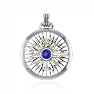 Silver circular pendant with intricate compass rose, blue gemstone, gold accents.