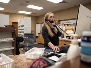 Crystal McEntire answers the phone at Hyland's Pharmacy in Wheeler while looking up prescription information on March 21, 2026. 