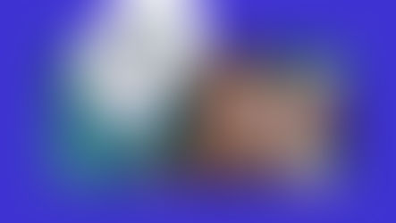 Woman smiling and waving while recording a birthday video message that says “Enjoy your day!”