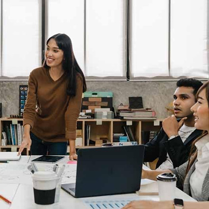 leaders around a table actively discussing a business problem with a facilitator.jpg