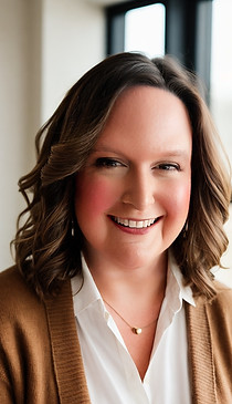 Picture of Laura Granville smiling wearing a white blouse and a caramel cardigan.