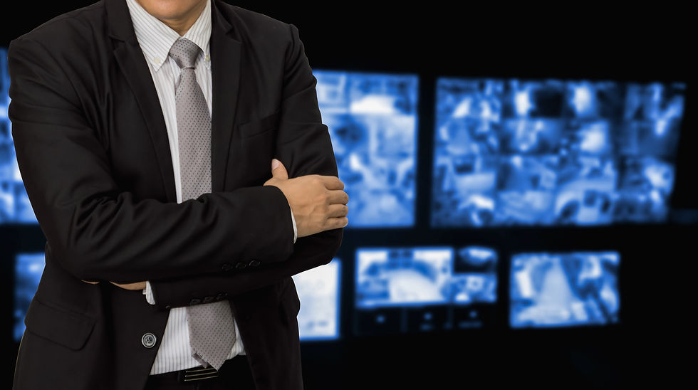 vecteezy_a-man-in-a-suit-and-tie-standing-in-front-of-a-screen_67852563.JPG