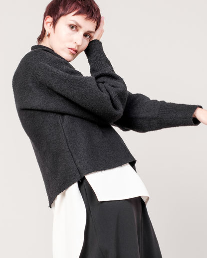 High-neck sweater with a soft, refined texture and a clean, minimal silhouette. The elevated neckline and smooth knit create a modern, quiet elegance. DOMELLE 25AW look.