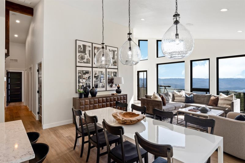 Modern custom home living room with floor to ceiling windows lake views and open concept layout North Idaho custom builder