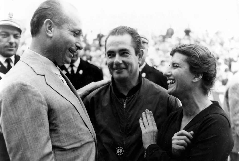 Argentine driver Juan Manuel Fangio and Italian Maserati driver Maria Teresa De Filippis engaged in a pleasant conversation during the Monaco Grand Prix