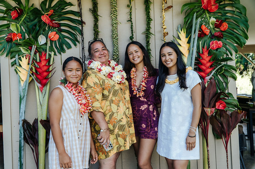 Family wearing leis at a tropical celebration