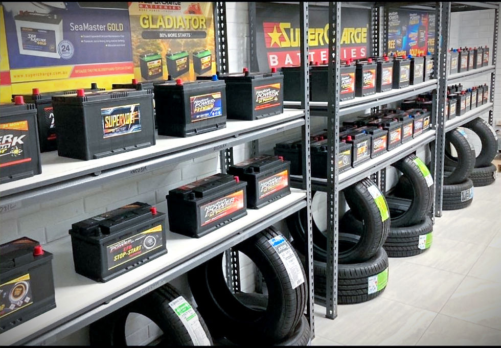 High angle view of various car batteries displayed on a workshop shelf