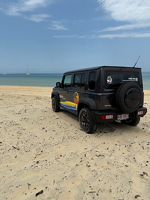 Grey 5-door Suzuki Jimny parked on the beach at Moreton Island at the Tangalooma Wrecks