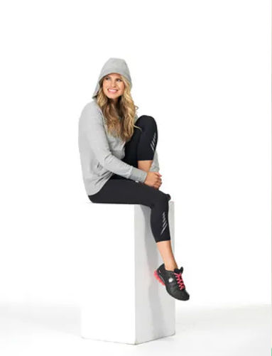 Woman in gray hoodie and black leggings
