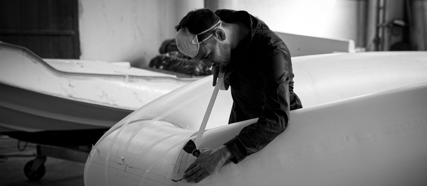 Artisan meticulously crafting a boat hull