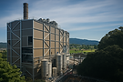 Industrial power plant with tall smokestack and silos