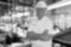 Smiling meat inspector in a facility