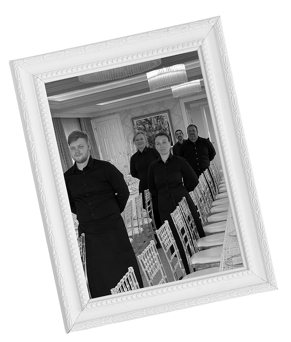 Servers in all black uniform waiting to serve a That Special Event private gathering. Photo is black nd white inside a white vintage frame.