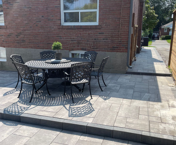 This interlock patio was out of date and needed CJS Landscaping to save there backyard. The existing pavers were disposed of and the base regarding with high performance bedding. We then installed new interlocking with a raised patio to separate it from the walkway, which leads around to the front yard.