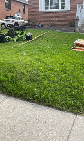 This driveway was extended with interlocking. A retaining wall was built to retain the lawn and garden. The interlock continued around both sides of the house with the walkways leading to a patio in the backyard. 