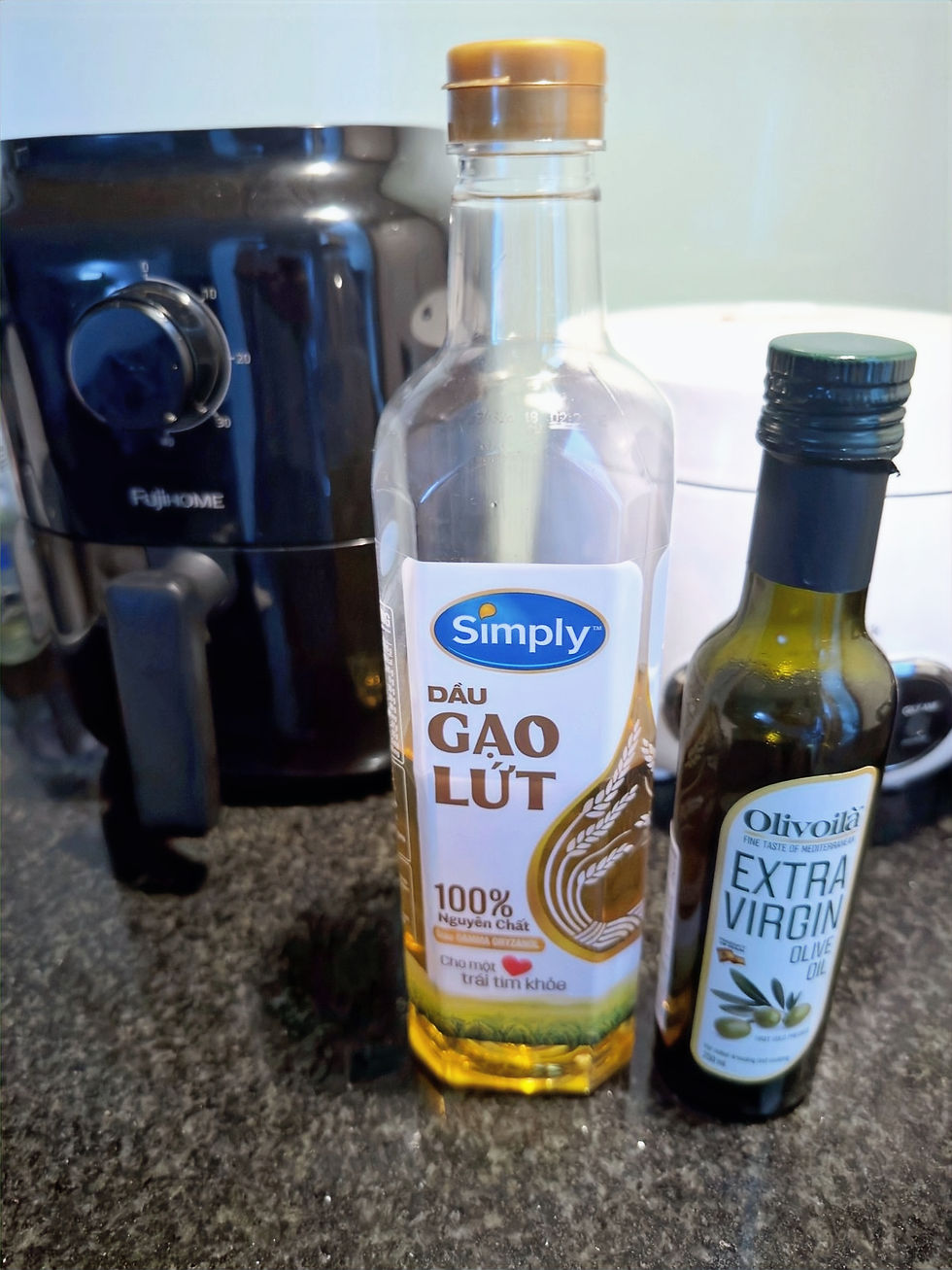 Local Simply rice bran oil next to a small bottle of imported extra virgin olive oil.