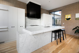 kitchen with marble bench and feature rangehood