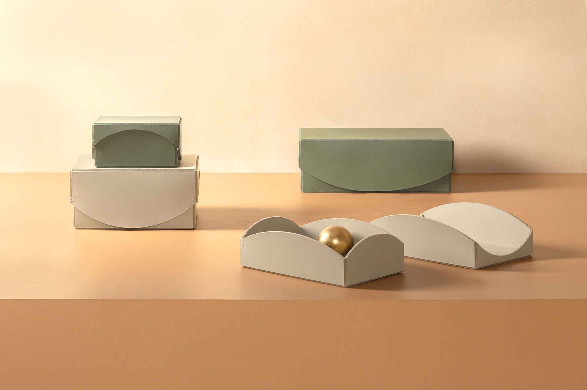 Group of Pieces boxes by Rabitti 1969 x PIET BOON shown in green and cream leathers.