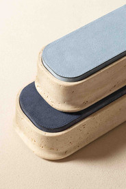 Long rectangular Rodi boxes by Giobagnara, shown in natural travertine with blue suede-covered lids