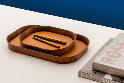 Two leather-inlaid valet trays with rounded rectangular shape