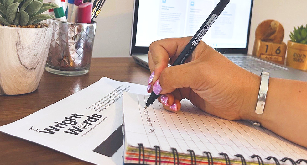 Person writing in a notebook near The Wright Words logo.