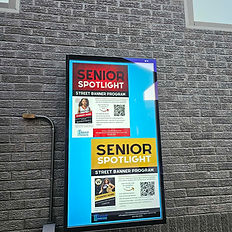 Lighted display featuring two 'Senior Spotlight' posters
