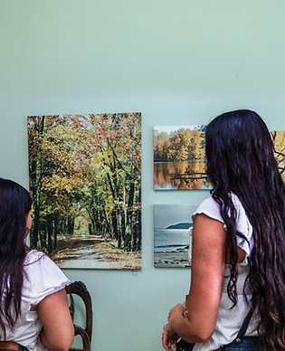An image of 2 girls viewing a painting in the Arts Unleashed Presents: The Gallery.