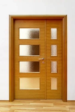 Contemporary double wooden entrance door with multiple frosted glass panels and sleek metal handle crafted by glass wooden door manufacturers in Ahmedabad.