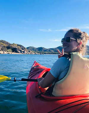 Close up of woman in sea kayak on ocean